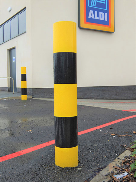 Protection banded security bollard with high-visibility bands, ensuring robust perimeter defense.