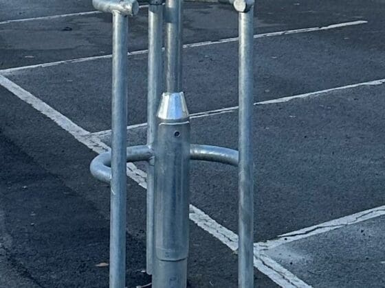 A durable horseshoe-shaped column protector, designed to absorb impact and protect pedestrians and vehicles in a parking lot.