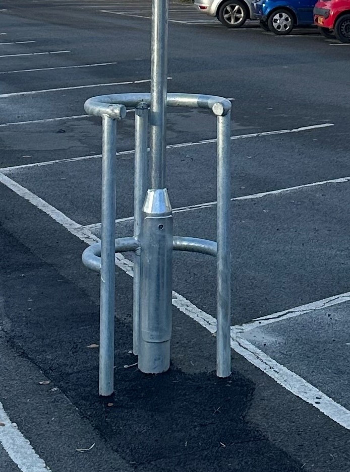 A durable horseshoe-shaped column protector, designed to absorb impact and protect pedestrians and vehicles in a parking lot.