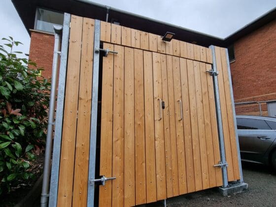 Fire rated commercial bin store, featuring fire-treated timber slats and a robust mild steel frame, designed to meet fire rating class 'C'