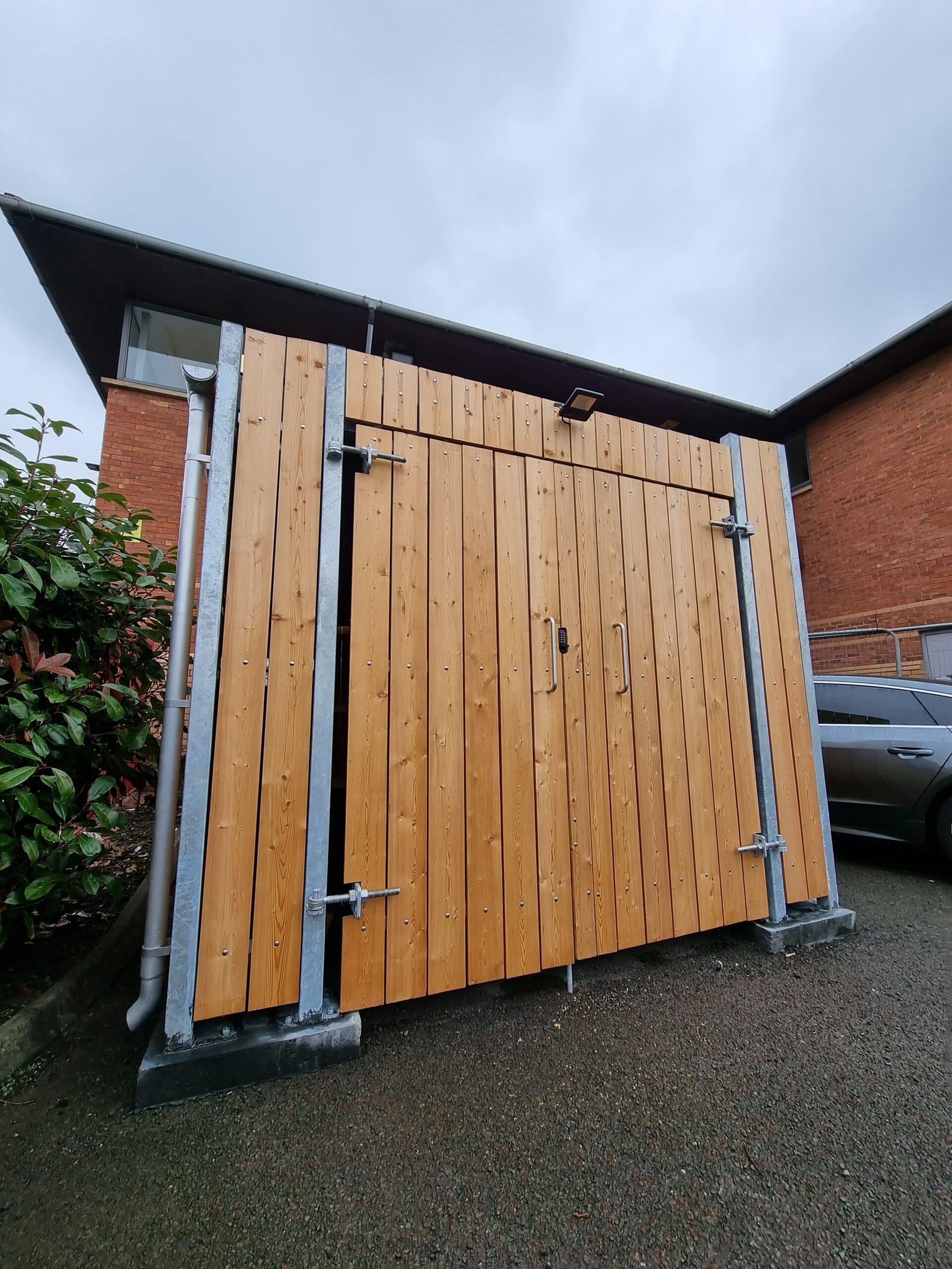 Fire rated commercial bin store, featuring fire-treated timber slats and a robust mild steel frame, designed to meet fire rating class 'C'